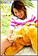 Inserting Dildo Into Bear Clutched Between Her Thighs