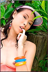 Thai Girls Biting Finger Sitting Topless Against Tree Stump Wearing Colourful Bangles