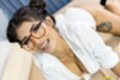 Jazzy in glasses showing cleavage in white shirt