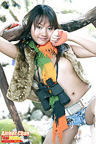 Wearing jacket in denim shorts binoculars around her neck wearing scarf