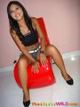 Sitting on red seat long hair crop top denim shorts high heels